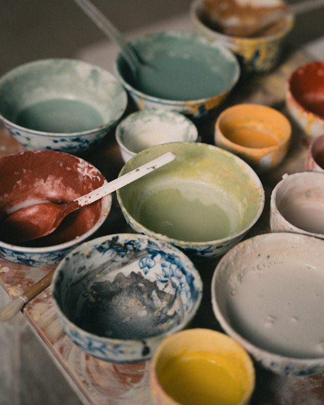 Bowls of mixed glazes on a table